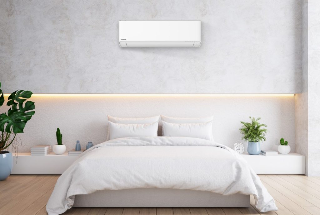 Modern bedroom with wall-mounted Panasonic ductless mini split heat pump for efficient year-round heating and cooling in Nova Scotia